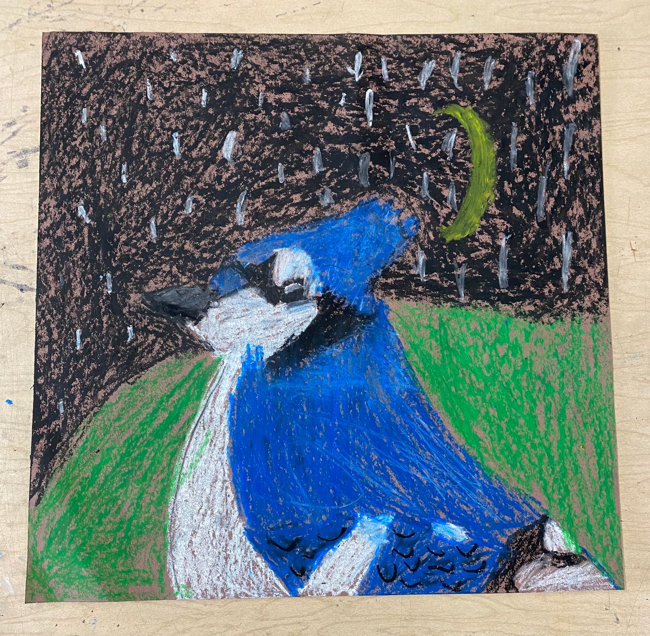 A young artist's portrait of a blue jay in crayon. The jay is in front of a night sky filled with stars and a crescent moon.
