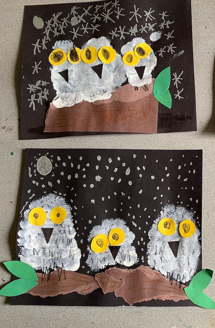 Two paint brush projects by Kindergarteners of snowy owls with big yellow eyes. 
