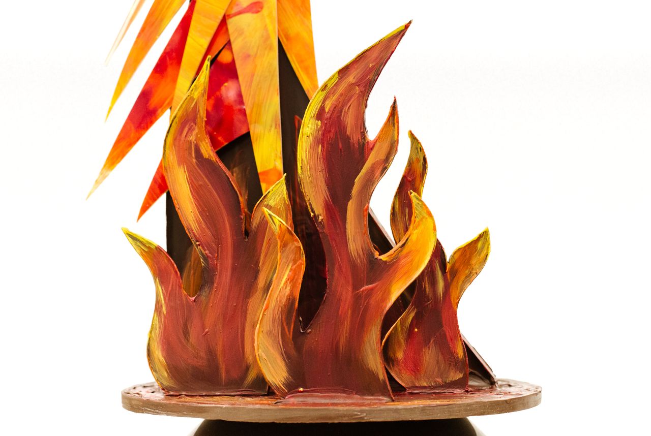 A close-up of a base of a chocolate sculpture with chocolate flames.