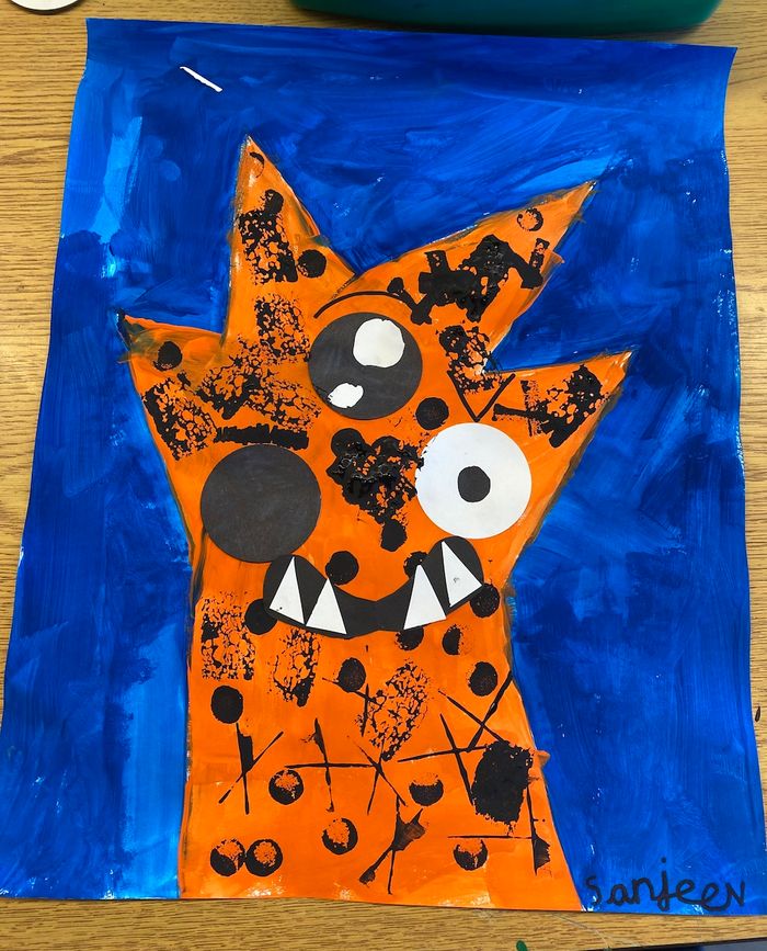 A bright orange monster on a blue background. It's hair is spiky, it has three eyes, and some sharp teeth coming out of the bottom of its mouth. It looks very friendly.